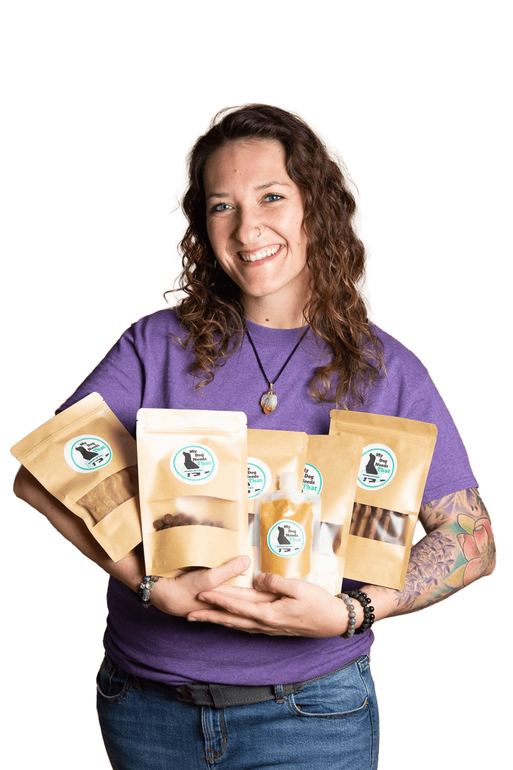 Gabby, the founder and owner of My Dog Needs That, holds bags of nutritious, carefully-made dog treats in her hands.